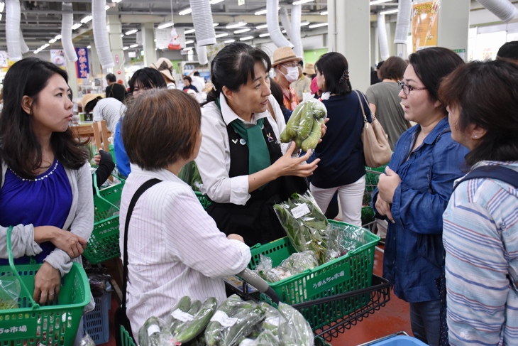 丁寧に野菜の説明をする堀さん
